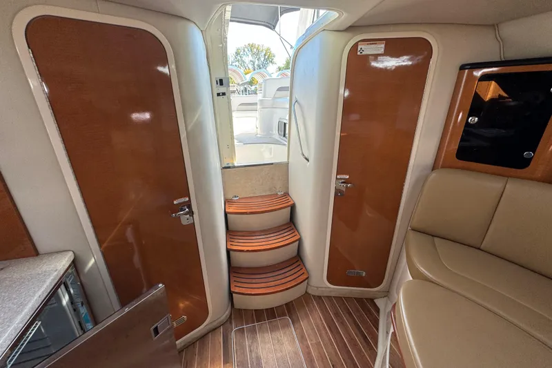 Slide: The Image of 2007 Chaparral Signature 330 interior with wooden doors, steps, and seating area. - 26