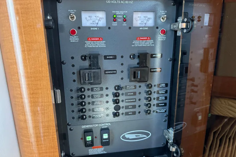 Slide: The Image of Electrical control panel of a 2007 Chaparral Signature 330 boat, featuring various switches and meters. - 27