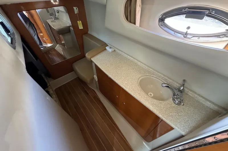Slide: The Image of 2007 Chaparral Signature 330 bathroom with sink, mirror, and wooden flooring. - 30