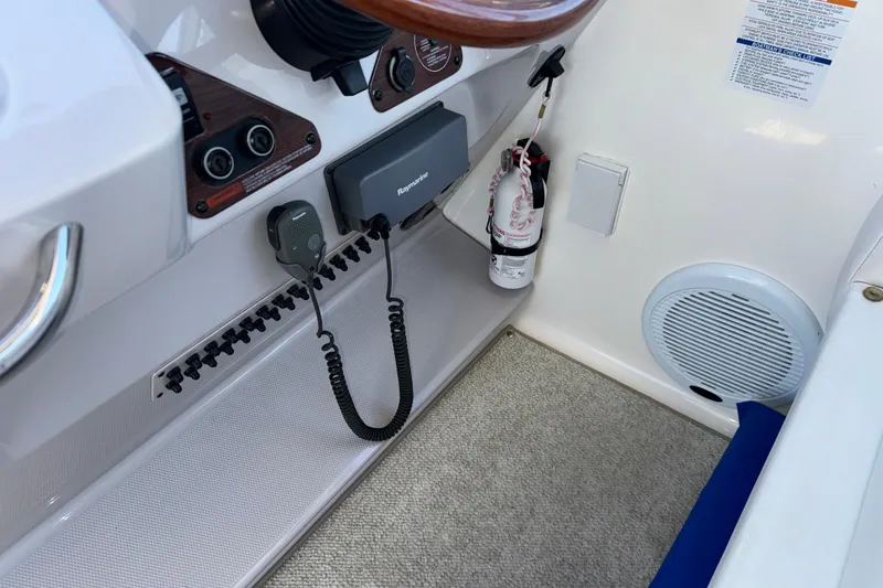 Slide: The Image of 2007 Chaparral Signature 330 boat interior with control panel and fire extinguisher. - 35