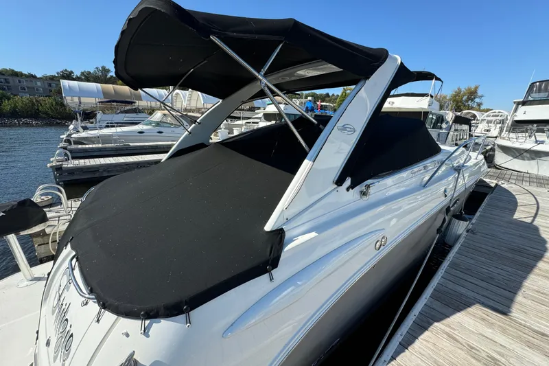 Slide: The Image of 2007 Chaparral Signature 330 boat docked with black canopy cover. - 7