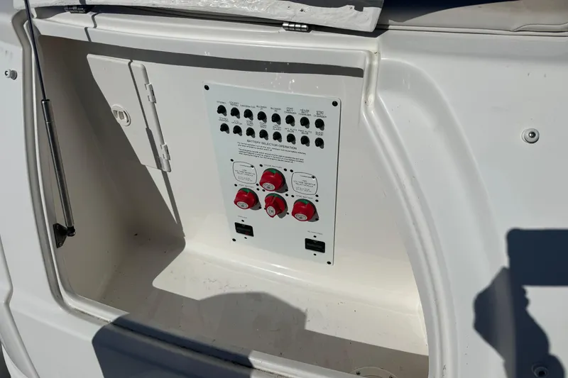 Slide: The Image of 2007 Chaparral Signature 330 boat electrical panel with switches and battery selectors. - 8