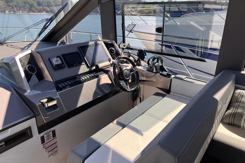 Slide: The Image of 2024 Galeon 425 HTS helm with modern controls and panoramic water view. - 15