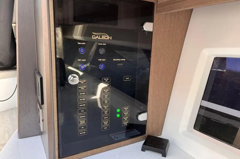 Slide: The Image of 2024 Galeon 425 HTS control panel with switches and indicators. - 19