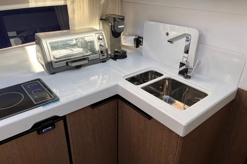 Slide: The Image of Modern kitchen in 2024 Galeon 425 HTS yacht with appliances and dual sink. - 21
