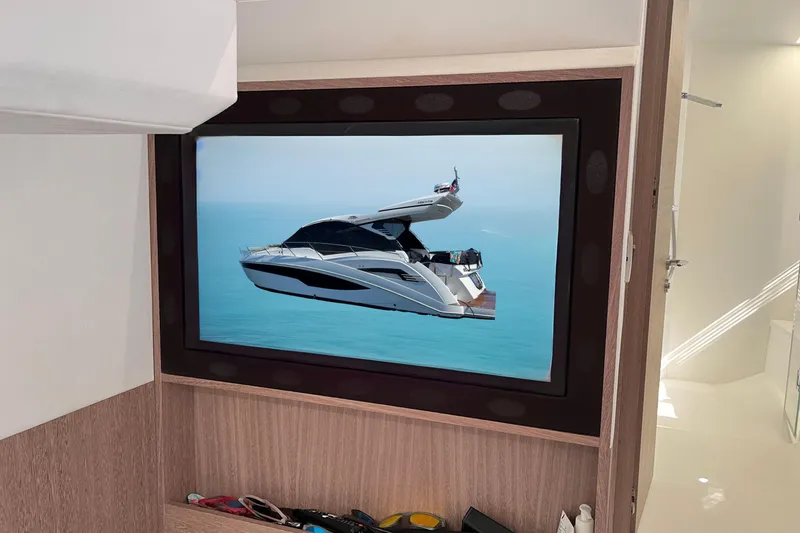 Slide: The Image of 2024 Galeon 425 HTS yacht displayed on a wall-mounted screen in a modern interior. - 28