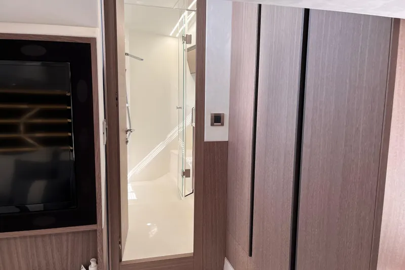 Slide: The Image of Interior of 2024 Galeon 425 HTS yacht, featuring modern wood paneling and sleek bathroom design. - 29