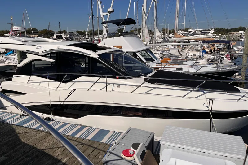Slide: The Image of 2024 Galeon 425 HTS yacht docked at marina, surrounded by other boats. - 3