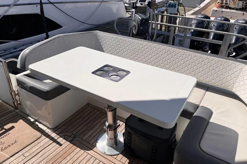Slide: The Image of Luxury seating area on 2024 Galeon 425 HTS yacht with elegant table and cushioned benches. - 8