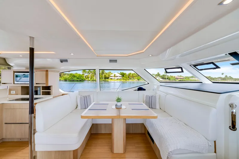 Slide: The Image of Luxurious interior of 2019 Aquila 44 Yacht with modern seating and panoramic windows. - 11