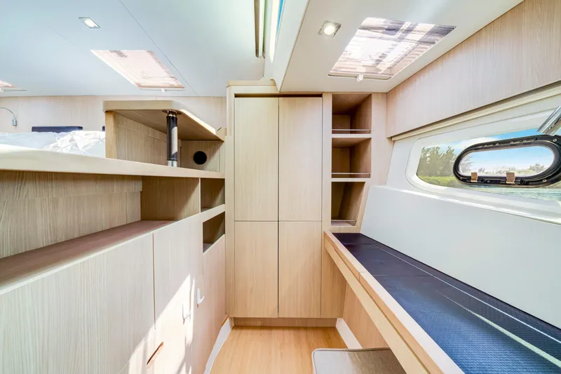 Slide: The Image of Luxurious interior of 2019 Aquila 44 Yacht with modern wood finish and ample natural light. - 17