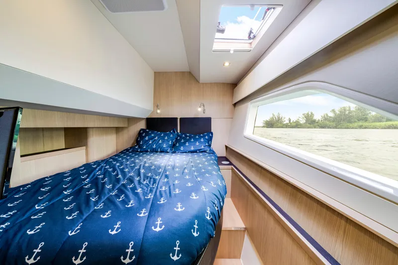 Slide: The Image of Interior of 2019 Aquila 44 Yacht featuring cozy bedroom and modern wooden staircase. - 27