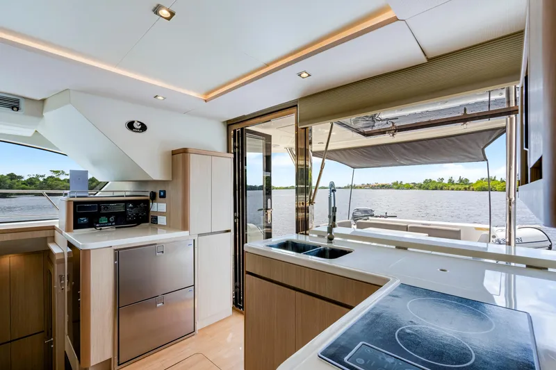Slide: The Image of Interior of 2019 Aquila 44 Yacht featuring modern kitchen and scenic water view. - 30