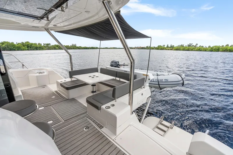 Slide: The Image of 2019 Aquila 44 Yacht interior with modern seating and open deck view. - 35