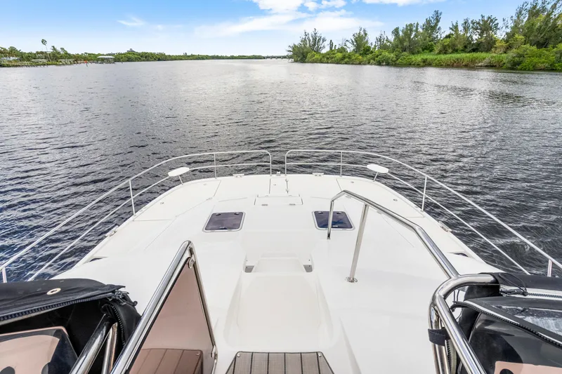 Slide: The Image of Aquila 44 Yacht 2019 cockpit with clear canopy, sleek design, and scenic water view. - 44
