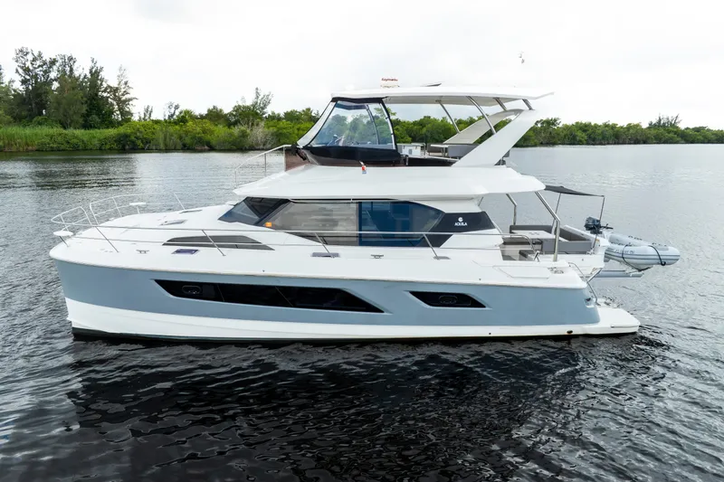 Slide: The Image of 2019 Aquila 44 Yacht cruising on calm waters, showcasing sleek design and modern features. - 52