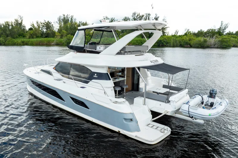 Slide: The Image of 2019 Aquila 44 Yacht on calm water, showcasing sleek design and modern features. - 53