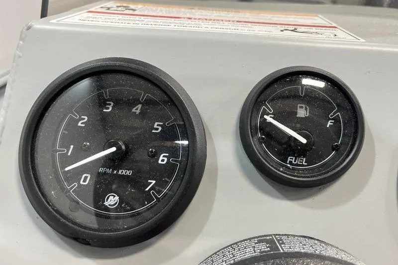 Slide: The Image of Dashboard gauges of 2025 SeaArk 1860 MVJT boat, showing RPM and fuel levels. - 10