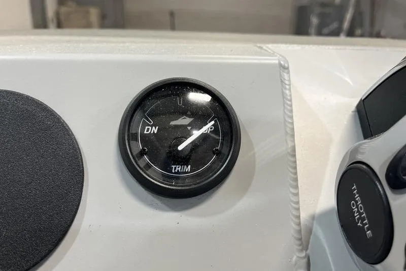 Slide: The Image of 2025 SeaArk 1860 MVJT boat trim gauge and throttle control panel. - 11