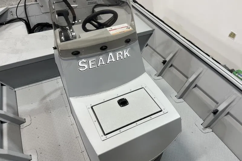 Slide: The Image of 2025 SeaArk 1860 MVJT boat interior with steering console and storage compartment. - 12