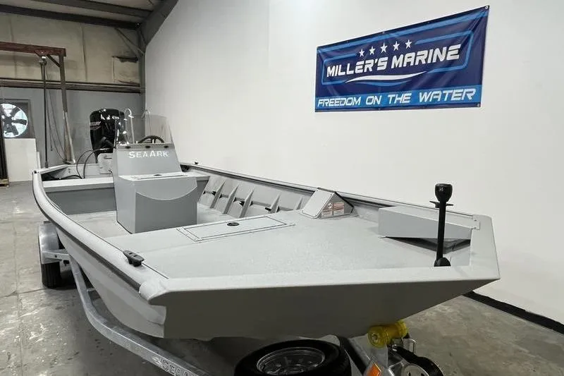 Slide: The Image of 2025 SeaArk 1860 MVJT boat displayed at Miller's Marine showroom. - 2