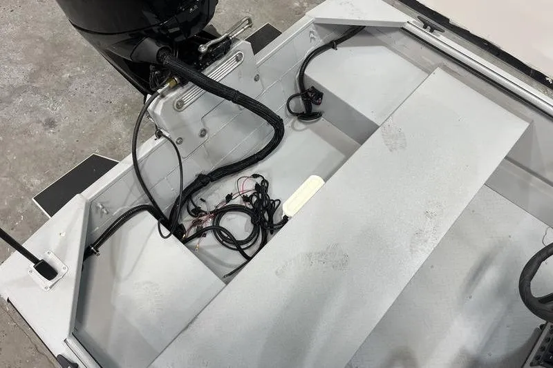 Slide: The Image of 2025 SeaArk 1860 MVJT boat interior with motor and wiring visible. - 6