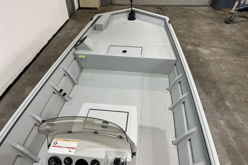 Slide: The Image of 2025 SeaArk 1860 MVJT boat interior with console and storage compartments. - 7