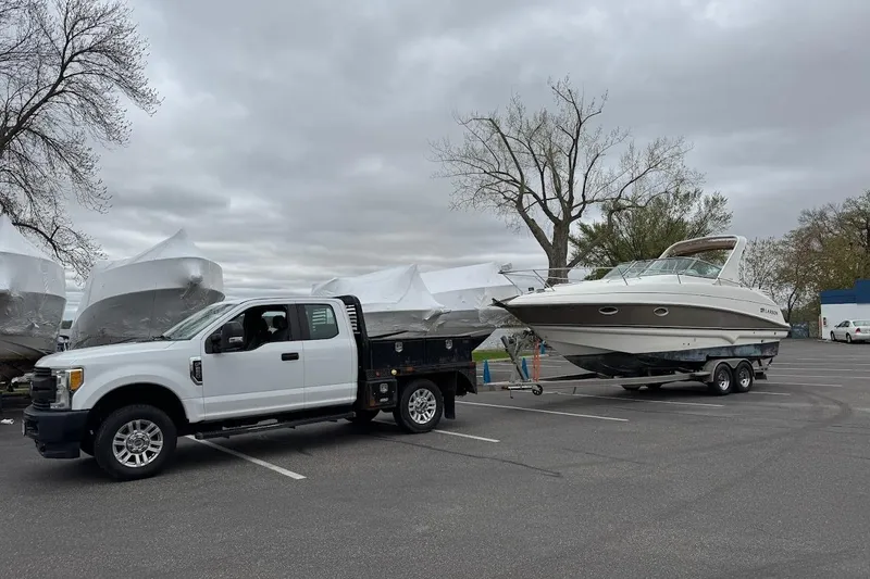 Slide: The Image of 2006 Larson Cabrio 274 boat interior with seating, canopy, and lake view. - 7