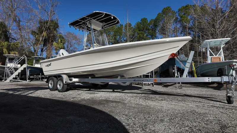 The Image of 2025 Bulls Bay 2200XS boat on trailer, parked outdoors, surrounded by trees. - 0