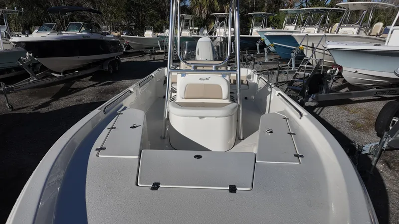 Slide: The Image of 2025 Bulls Bay 2200XS boat, sleek design, parked among other boats. - 11