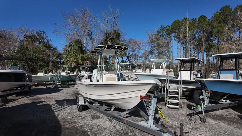Slide: The Image of 2025 Bulls Bay 2200XS boat on trailer in outdoor lot, surrounded by trees. - 3