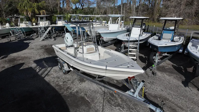 Slide: The Image of 2025 Bulls Bay 2200XS boat on trailer, surrounded by other boats in a lot. - 5