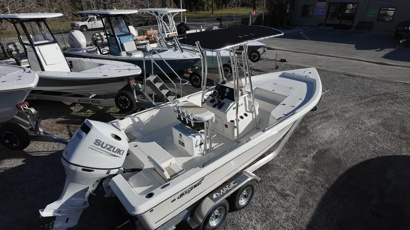 Slide: The Image of 2025 Bulls Bay 2200XS boat with Suzuki engine on trailer, parked outdoors. - 6