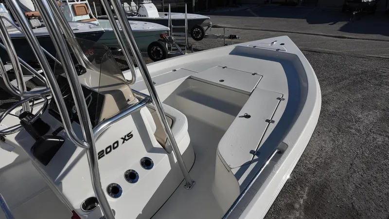 Slide: The Image of 2025 Bulls Bay 2200XS boat, white deck, center console, parked on gravel. - 9