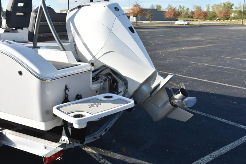 Slide: The Image of 2025 Sea Pro 245FLX Sandbar boat with powerful outboard motor in a parking lot. - 15