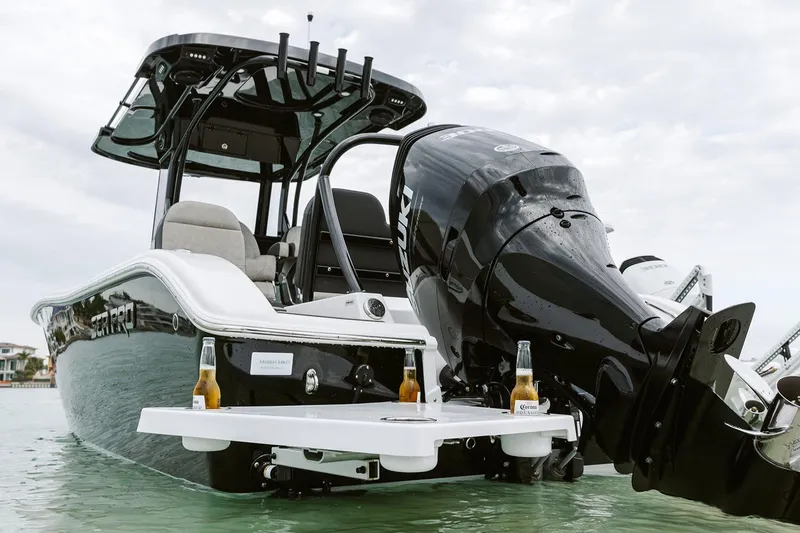 Slide: The Image of Manufacturer Provided Image: 2025 Sea Pro 245FLX Sandbar boat with outboard motor and drinks on swim platform. - 19
