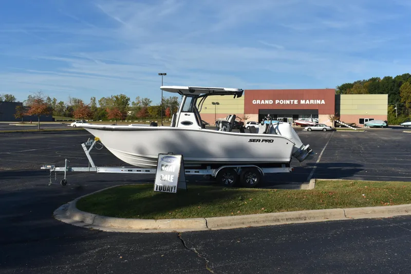Slide: The Image of 2025 Sea Pro 245FLX Sandbar boat on trailer at Grand Pointe Marina. - 2