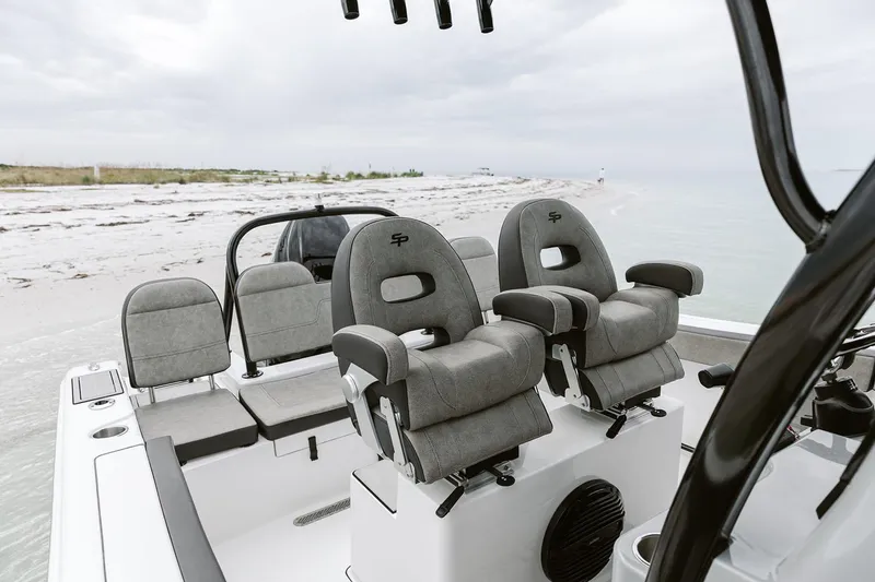 Slide: The Image of Manufacturer Provided Image: 2025 Sea Pro 245FLX Sandbar boat interior with plush seating, near a sandy beach. - 22