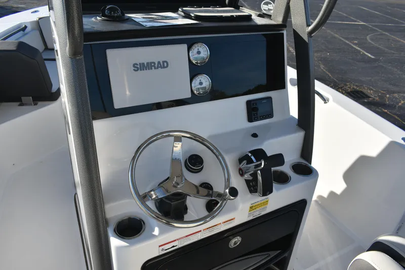 Slide: The Image of 2025 Sea Pro 245FLX Sandbar boat console with Simrad display and steering wheel. - 8