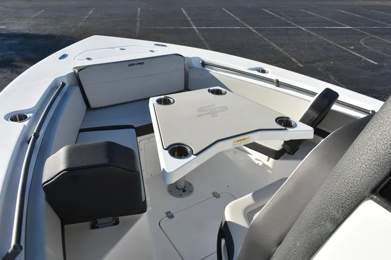 Slide: The Image of 2025 Sea Pro 245FLX Sandbar boat interior with seating and table setup. - 9