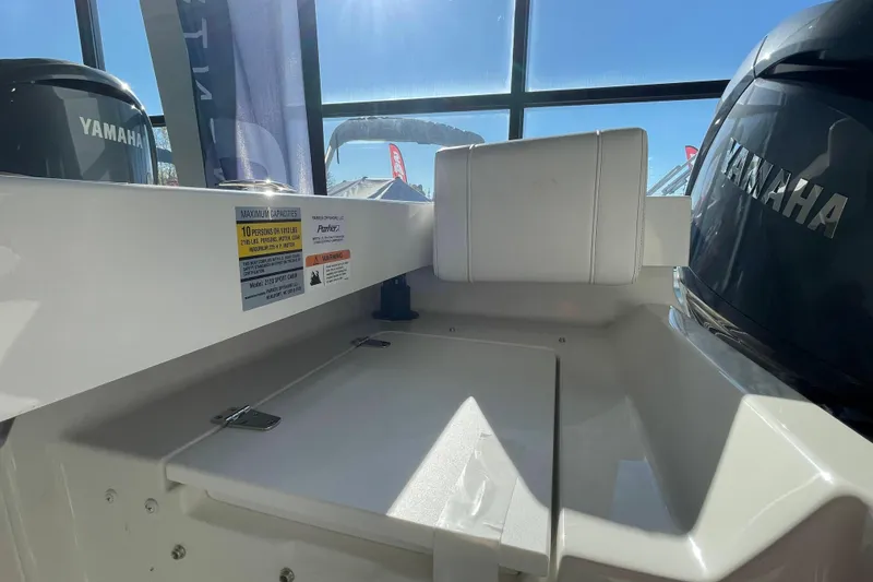Slide: The Image of Interior of 2026 Parker 217 Explorer boat with Yamaha engines, showcasing seating and capacity details. - 10