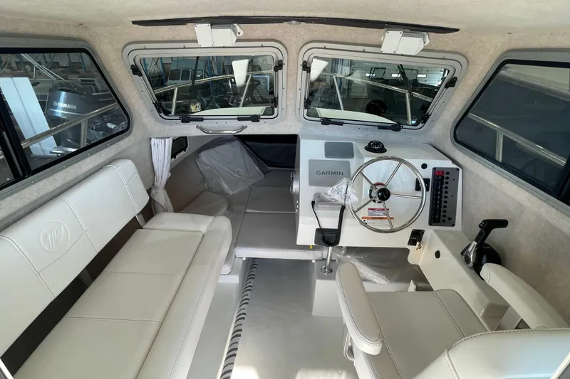 Slide: The Image of Interior of 2026 Parker 217 Explorer boat with Garmin navigation system and seating. - 11