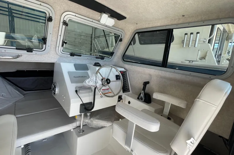 Slide: The Image of Interior of 2026 Parker 217 Explorer boat with Garmin navigation system and steering wheel. - 13