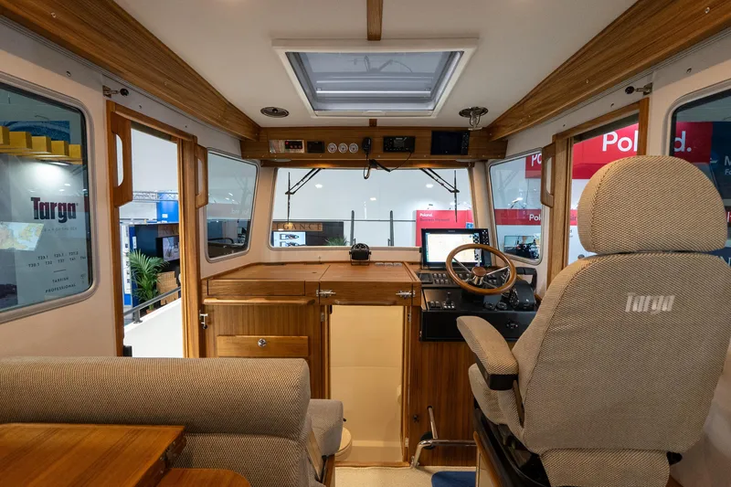 Slide: The Image of Targa 27.2 boat docked at marina, showcasing spacious deck and serene waterfront view. - 18