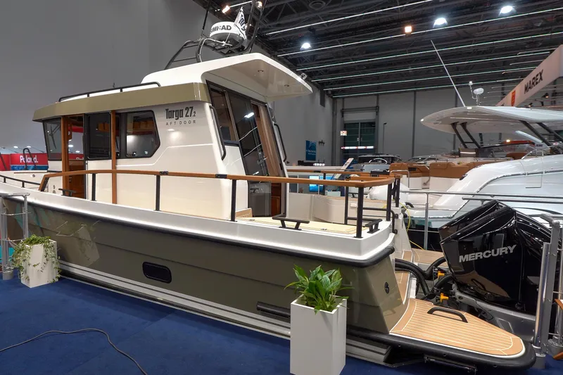 Slide: The Image of 2026 Targa 27.2 boat cruising at sunset on open water. - 2