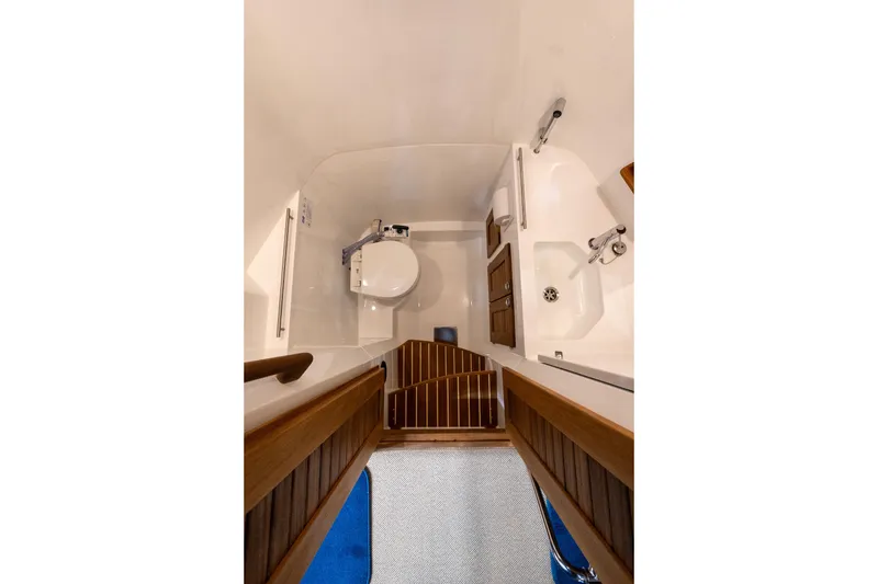 Slide: The Image of Side view of 2026 Targa 27.2 boat docked by a wooden pier. - 21