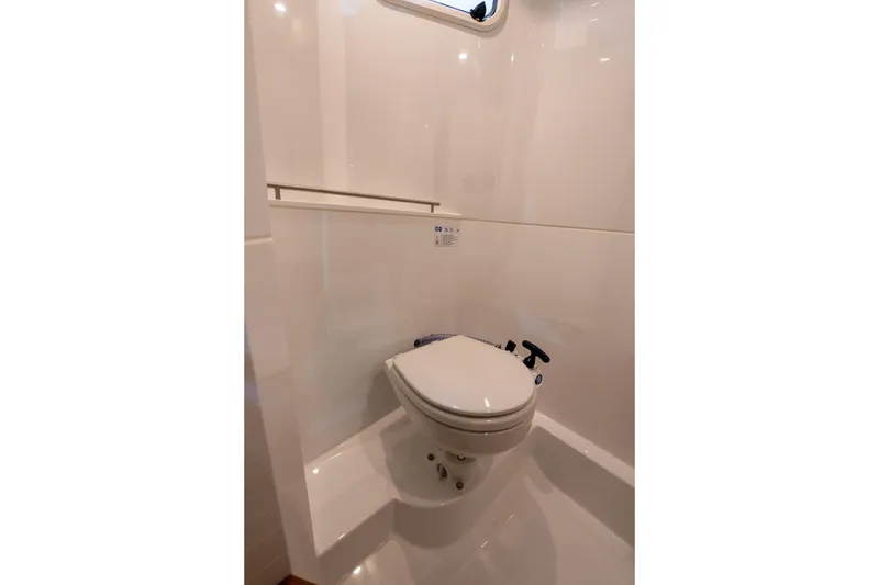 Slide: The Image of Storage compartment of 2026 Targa 27.2 boat with blue hose and metal flooring. - 26