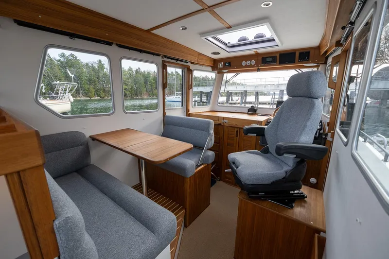 Slide: The Image of Interior of 2026 Targa 27.2 boat with seating, table, and helm station. - 46