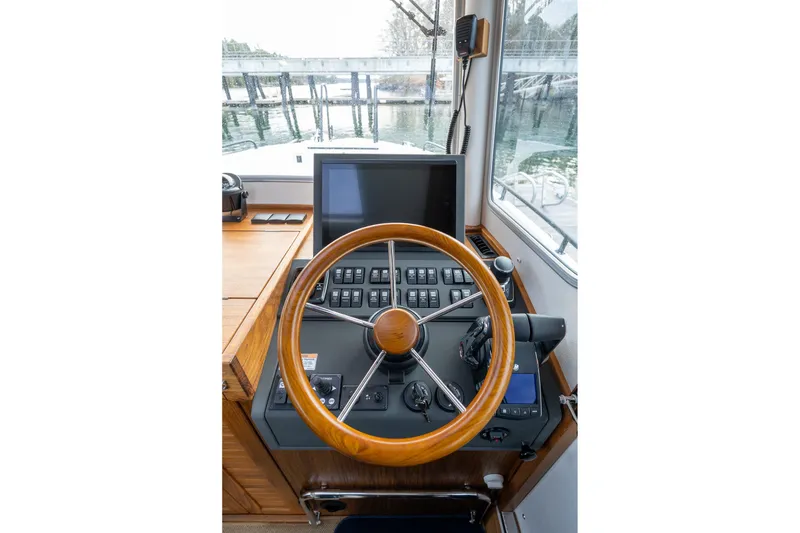 Slide: The Image of Helm of 2026 Targa 27.2 boat with wooden steering wheel and control panel. - 49