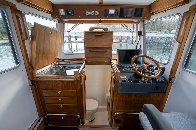 Slide: The Image of Interior of 2026 Targa 27.2 boat with wooden cabinetry and modern controls. - 58